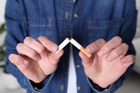 Closeup of person breaking cigarette