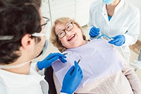 Woman smiling at dentist while sitting in treatment chair