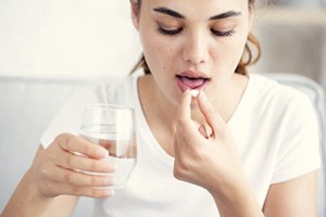 woman taking a pill 