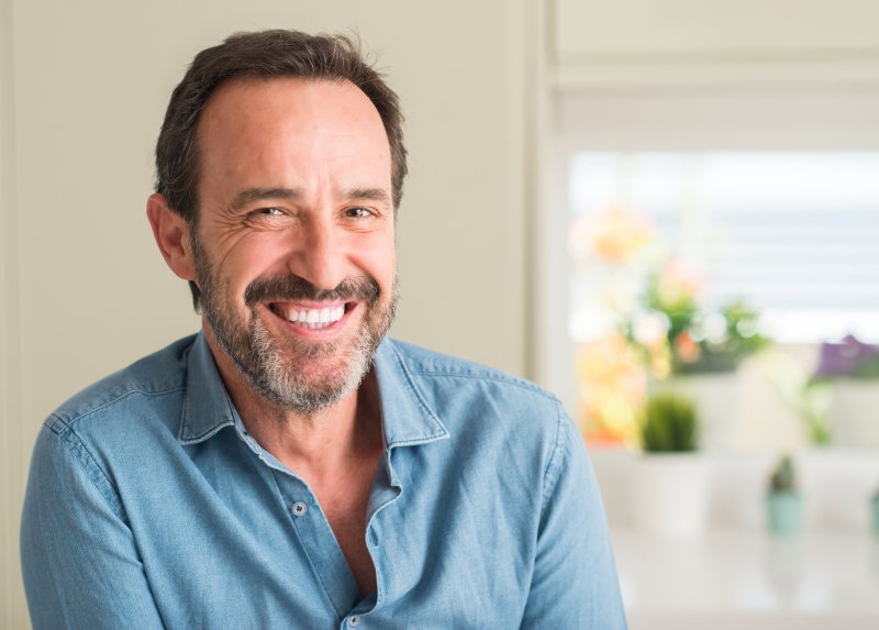 A man smiling with his new dental implants