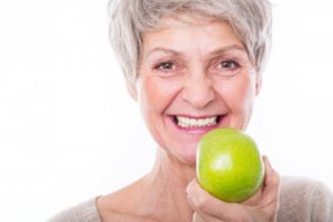 older woman preparing to eat