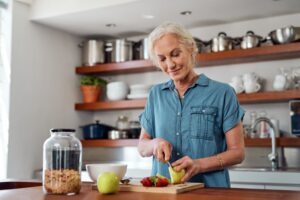 Woman with dentures preparing food