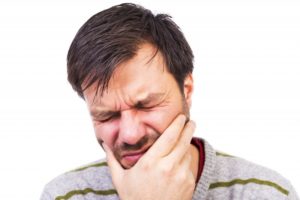 A man experiencing dental pain.