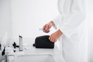 Man taking toothbrush out of his toiletry bag