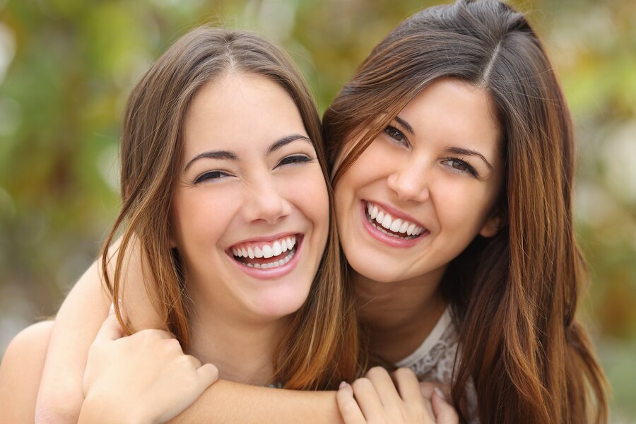 two people with cosmetic dentistry smiling